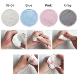Set of 12 reusable cotton makeup remover pads in blue, pink, gray, and beige with a hand demonstrating usage.