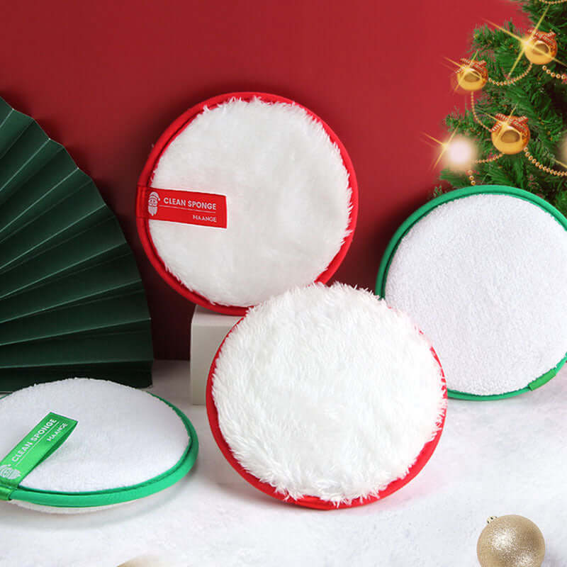 Cleansing face puff and makeup remover set with red and green natural sponges, four packs displayed on festive background.