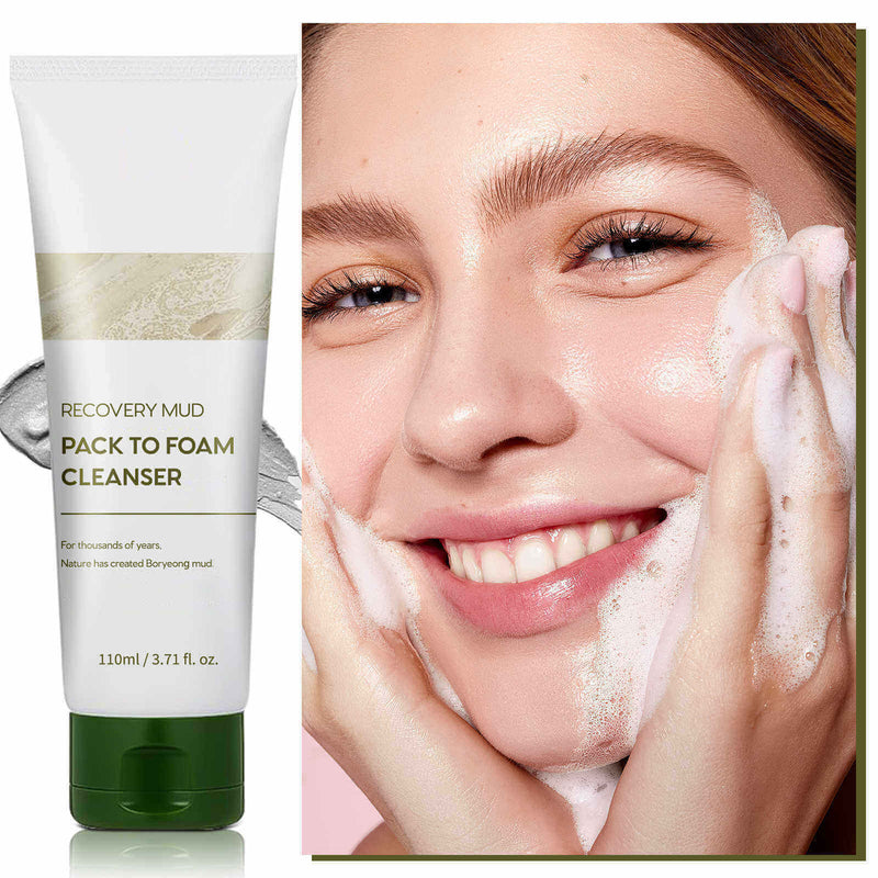 Woman using Recovery Mud Pack to Foam Cleanser, showcasing radiant skin and a bright smile for effective cleansing.
