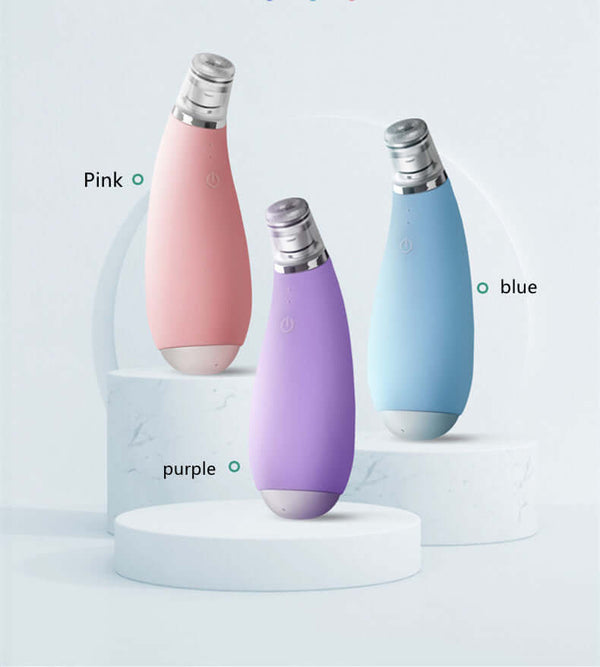 Exfoliating electric facial cleansing device in pink, purple, and blue colors on display for skincare.