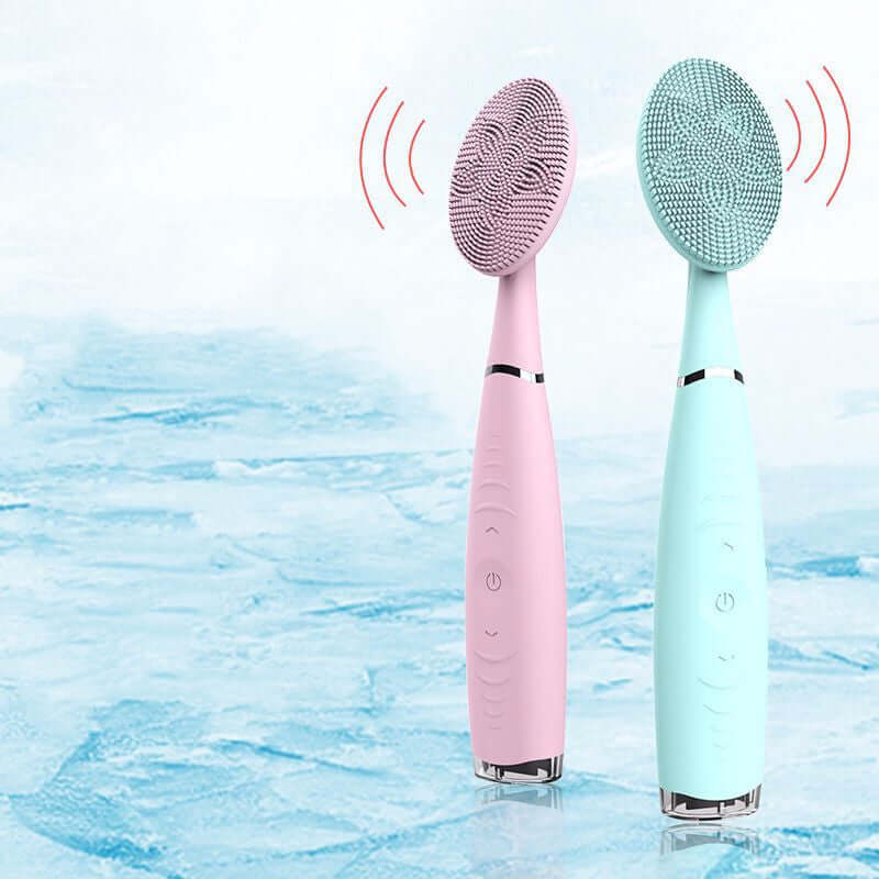 Facial cleansing brush set in pink and teal, featuring soft silicone bristles and high-frequency vibration technology.