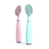 Facial cleansing brush set in pink and blue, featuring silicone heads and portable handheld design for effective facial care.