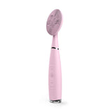 Portable pink silicone facial cleansing brush with high-density bristles for gentle skin care and deep cleaning.