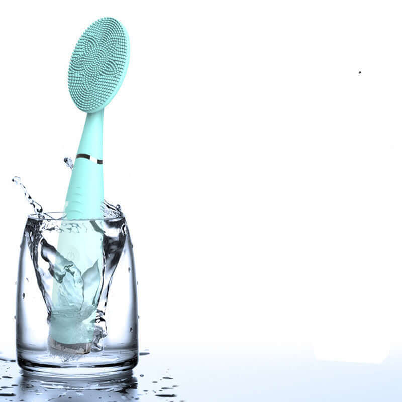 Waterproof silicone facial cleansing brush splashing in a glass, ideal for gentle facial cleaning and pore purification.