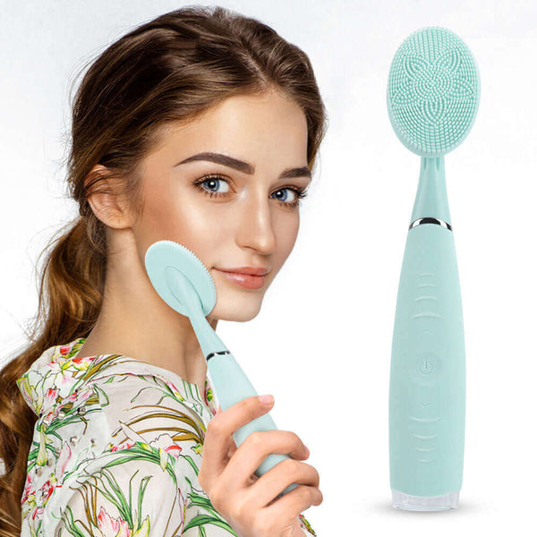 Woman demonstrating a mint green facial cleansing brush, showcasing skincare routine and beauty tools.