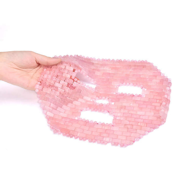 Jade face mask for facial massage treatment, showcasing its pink jade design and unique texture.