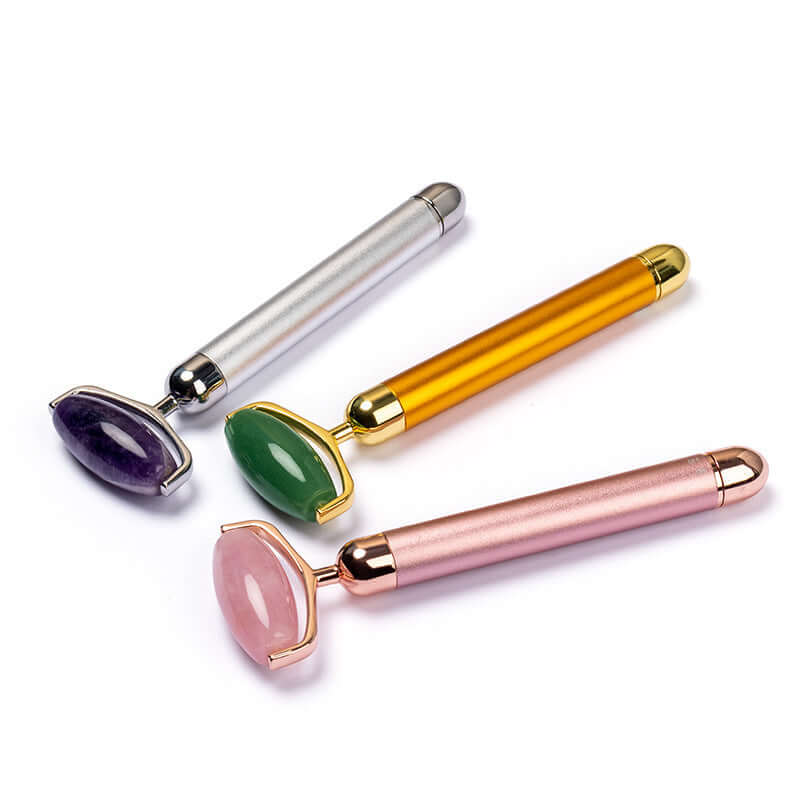 Jade roller electric massage sticks in rose gold, gold, silver for face beauty treatment.