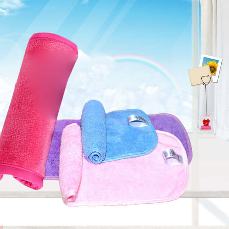 Colorful microfiber makeup remover towels in pink, blue, and purple against a bright sky backdrop.