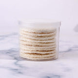 Reusable loofah facial wash puffs in a clear container, perfect for exfoliating and makeup removal.