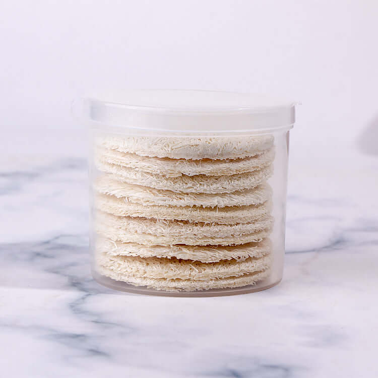 Reusable loofah facial wash puffs in a clear container, perfect for exfoliating and makeup removal.