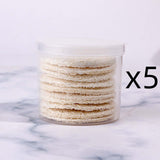 Pack of 5 reusable loofah facial wash puffs for gentle exfoliation and makeup removal, stored in a clear container.