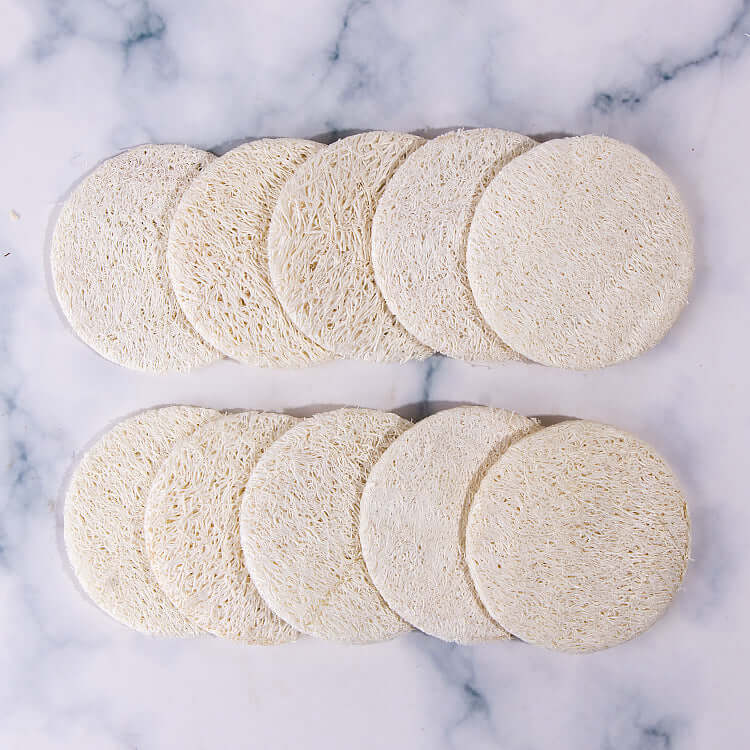 Set of round reusable loofah facial sponges for exfoliating and cleansing skin, ideal for makeup removal.