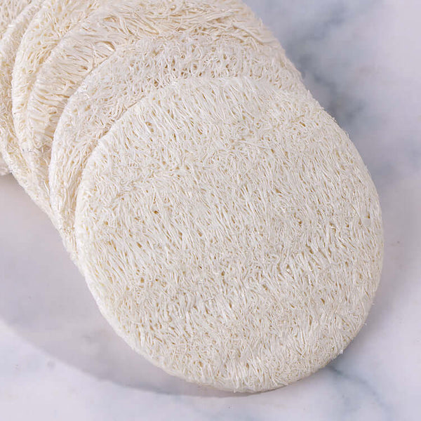 Round loofah exfoliating facial sponges for makeup and skin care, reusable and eco-friendly.