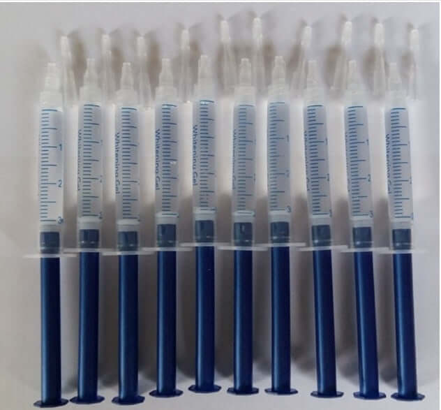 Ten syringes of teeth whitening gel, each marked with measurement lines for accurate application.
