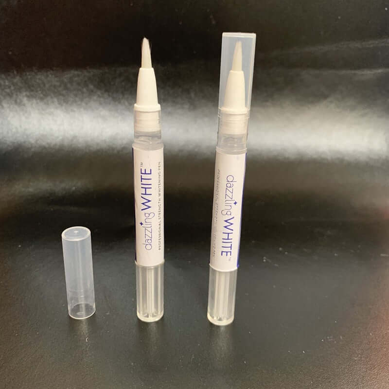 Transparent teeth whitening pen with cap, featuring carbamide peroxide gel for whitening teeth.