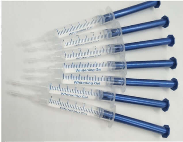 Set of whitening gel syringes, designed for effective teeth whitening treatments, featuring clear bodies and blue handles.