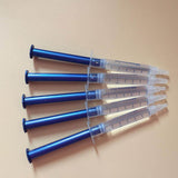 Set of four 3ml blue dental syringes containing teeth whitening gel for effective oral care treatments.